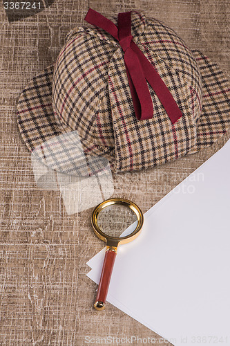 Image of Wrapped paper sheets and magnifying glass