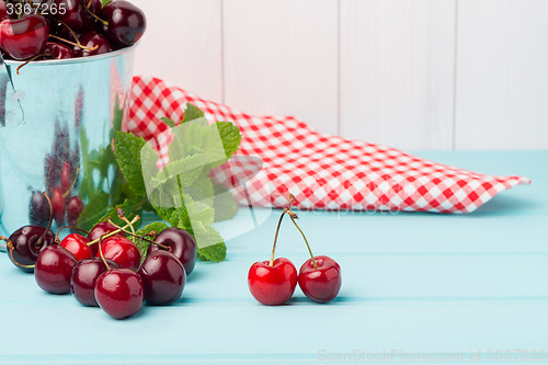 Image of Cherries in two small metal buckets