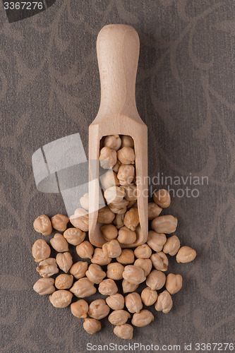 Image of Wooden scoop with chickpeas