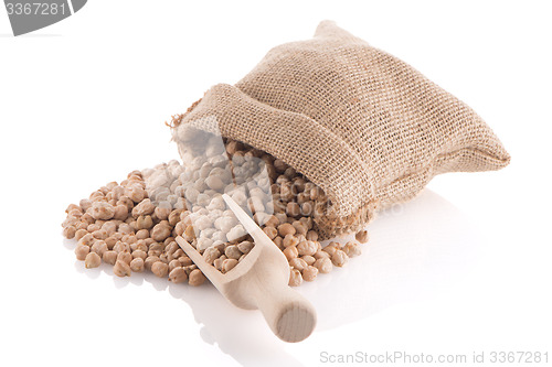 Image of Uncooked chickpeas and wooden scoop