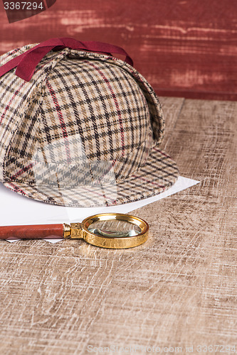 Image of Paper sheets and magnifying glass