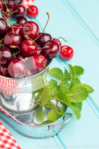 Image of Cherries in blue wooden table