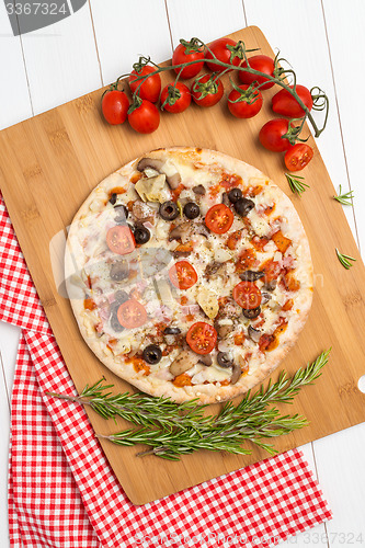 Image of Pizza with bacon, olives and tomato