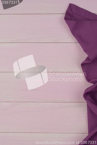 Image of Purple towel over wooden table