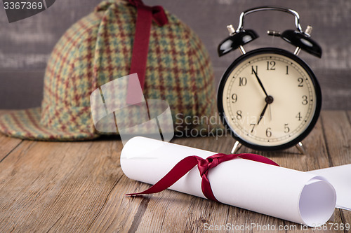 Image of Wrapped paper sheets and magnifying glass