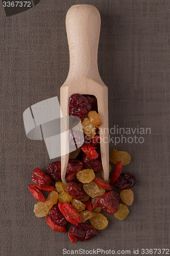 Image of Wooden scoop with mixed dried fruits