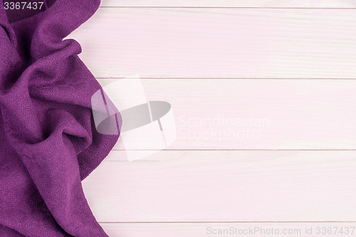 Image of Purple towel over wooden table