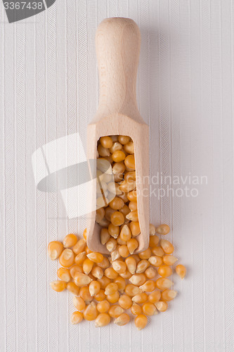 Image of Wooden scoop with corn