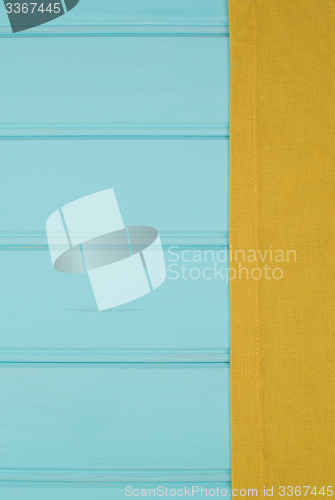 Image of Green towel over wooden table