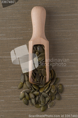 Image of Wooden scoop with pumpkin seeds