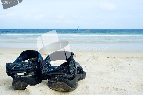 Image of Sandals on sandy beach

