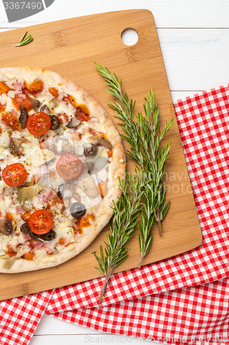 Image of Pizza with bacon, olives and tomato