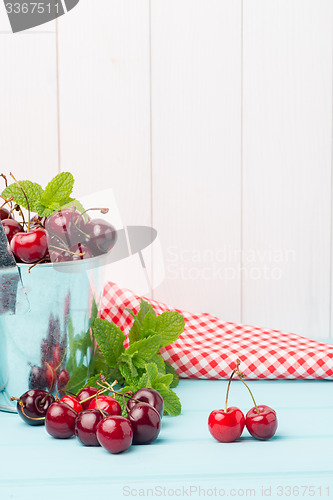 Image of Cherries in two small metal buckets