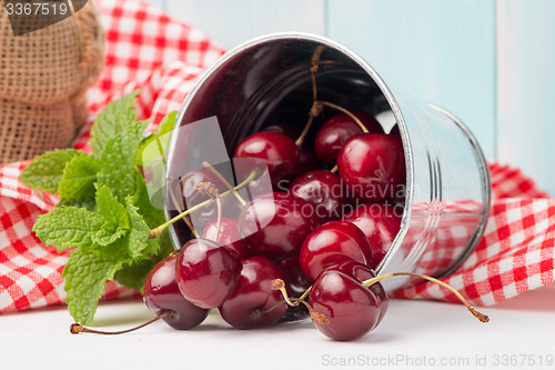 Image of Cherries in small metal bucket