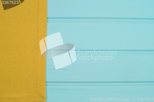 Image of Green towel over wooden table