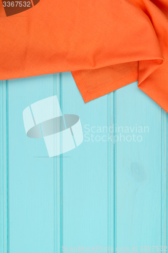 Image of Orange towel over wooden table