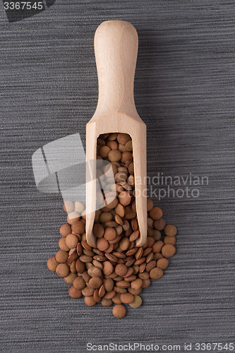 Image of Wooden scoop with lentils