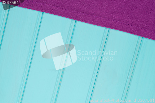 Image of Purple towel over wooden table