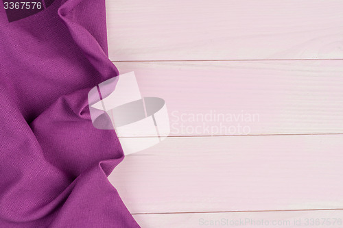 Image of Purple towel over wooden table