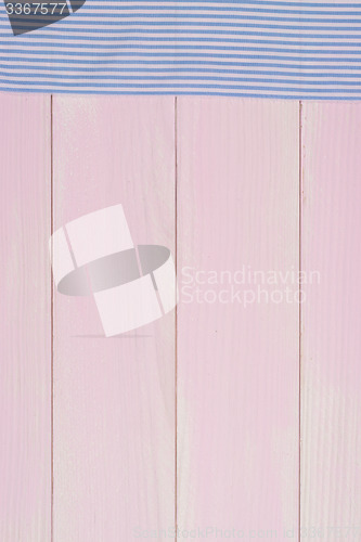 Image of White and blue towel over wooden table