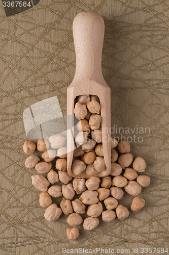 Image of Wooden scoop with chickpeas