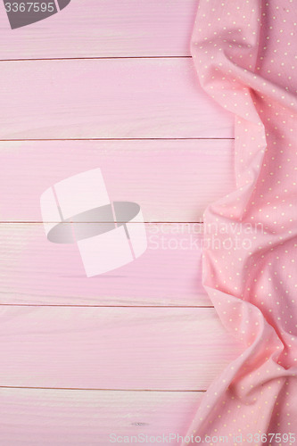Image of Pink towel over wooden table