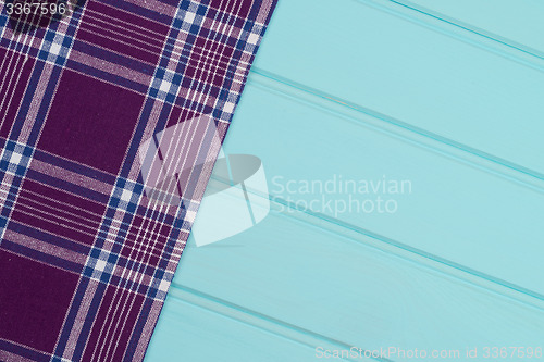 Image of Purple towel over wooden table