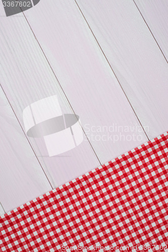 Image of White and red towel over wooden table