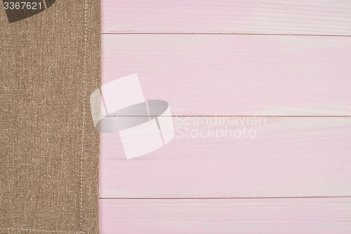 Image of Beige towel over wooden table