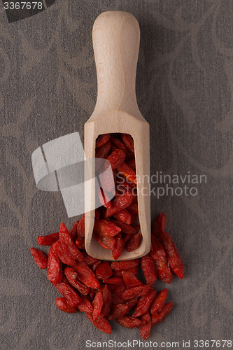 Image of Wooden scoop with dry red goji berries