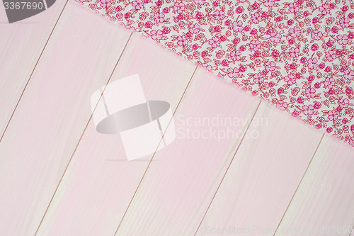 Image of Pink towel over wooden table