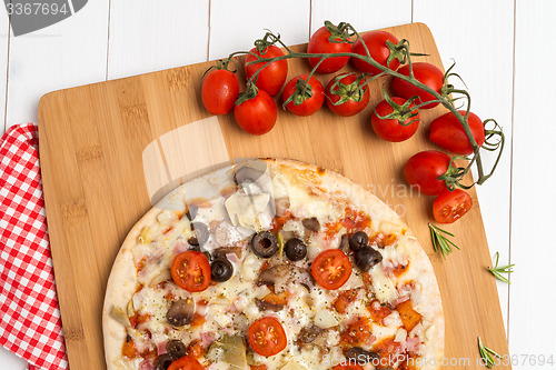 Image of Pizza with bacon, olives and tomato