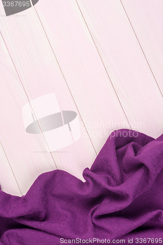 Image of Purple towel over wooden table