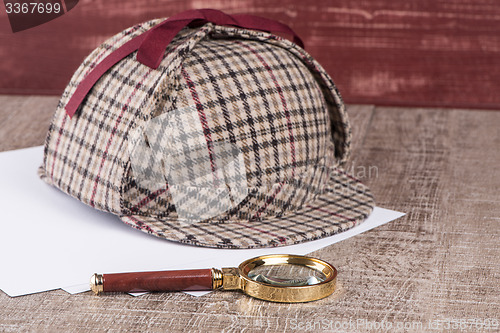 Image of Paper sheets and magnifying glass