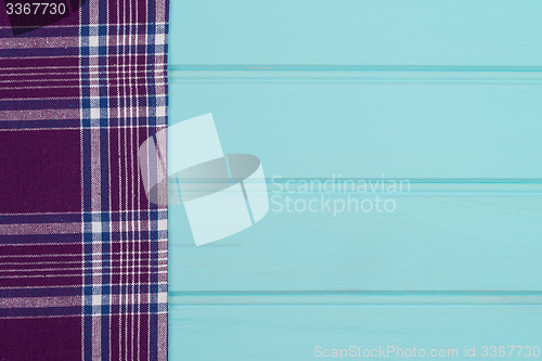 Image of Purple towel over wooden table