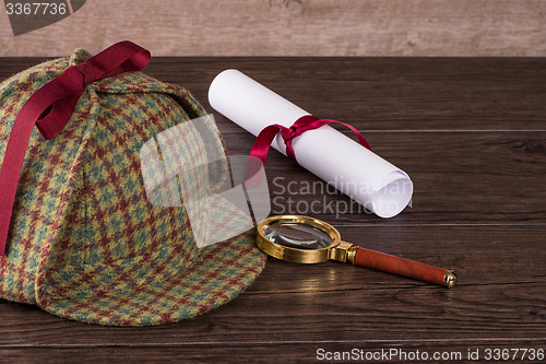 Image of Wrapped paper sheets and magnifying glass