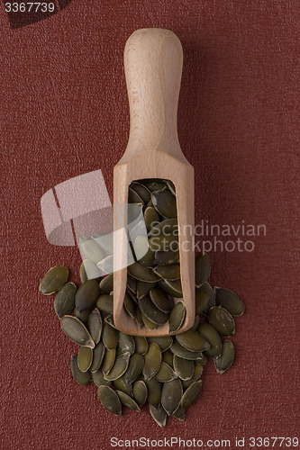 Image of Wooden scoop with pumpkin seeds