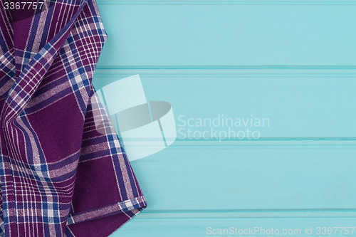 Image of Purple towel over wooden table