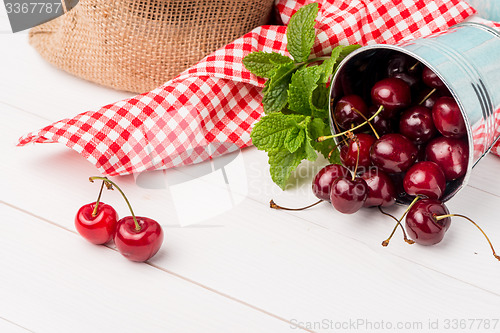Image of Cherries in small metal bucket
