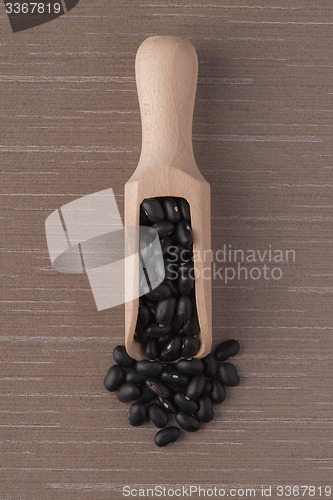 Image of Wooden scoop with black beans