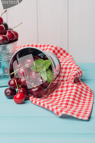 Image of Cherries in blue wooden table