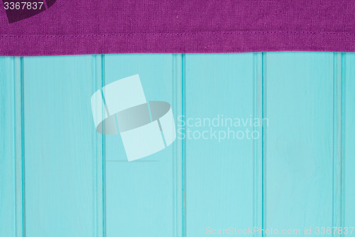 Image of Purple towel over wooden table