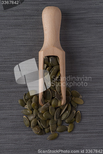 Image of Wooden scoop with pumpkin seeds