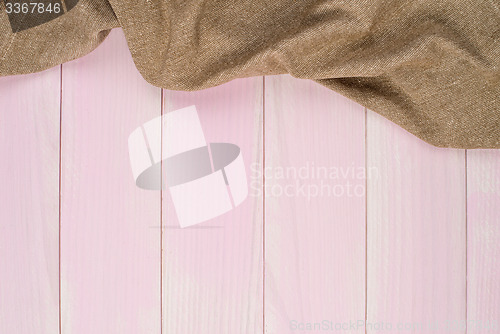 Image of Beige towel over wooden table