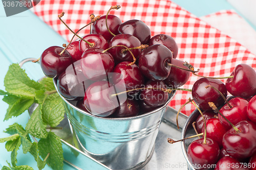 Image of Cherries in blue wooden table