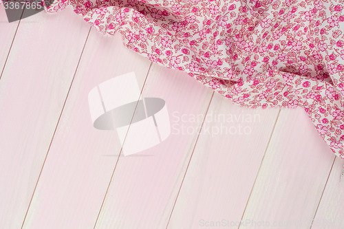 Image of Pink towel over wooden table