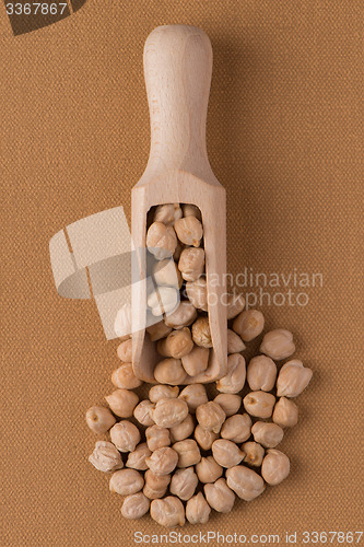 Image of Wooden scoop with chickpeas