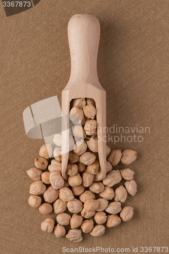 Image of Wooden scoop with chickpeas