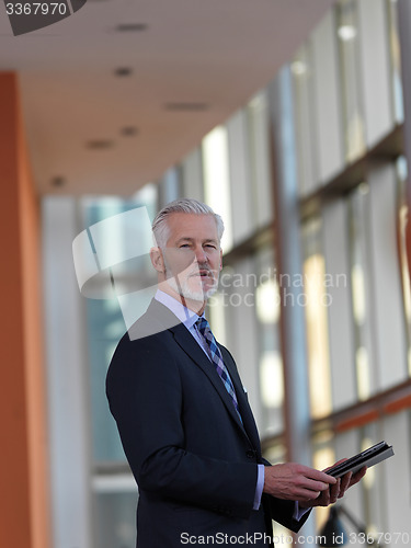 Image of senior business man working on tablet computer