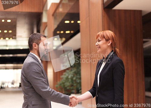 Image of businesswoman and businessman handshake